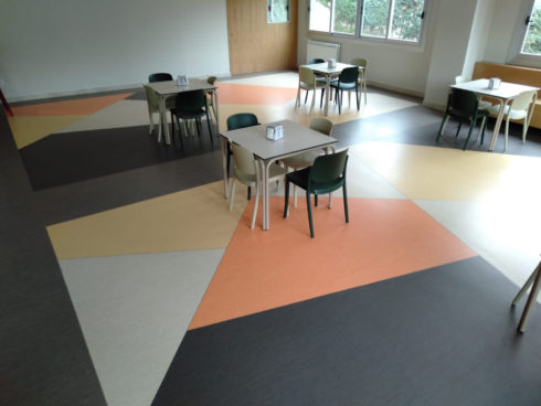 Suelo plástico con diseño en cafetería comedor colegio mayor
